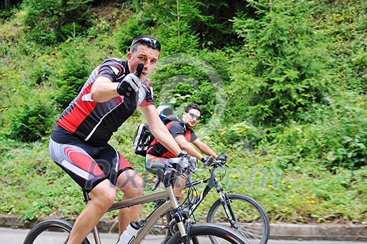 two friends have fun outdoor in nature and representing concept of healthy life and fitnes on muntain bike two friends have fun outdoor in nature and representing concept of healthy life and fitnes on muntain bike