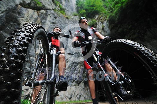 two friends have fun outdoor in nature and representing concept of healthy life and fitnes on muntain bike two friends have fun outdoor in nature and representing concept of healthy life and fitnes on muntain bike