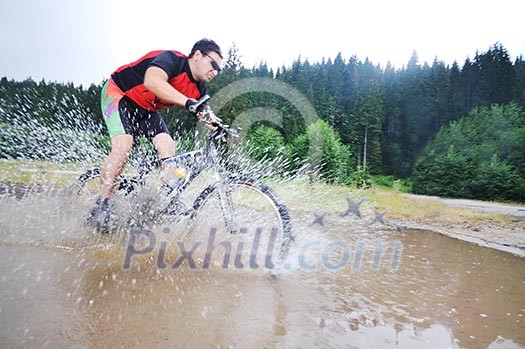 young man drive mountain bike over water river young man drive mountain bike over water river