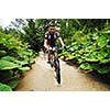 young man drive mountain bike over water river