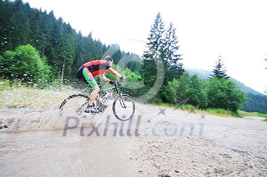 young man drive mountain bike over water river young man drive mountain bike over water river