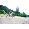 young man drive mountain bike over water river