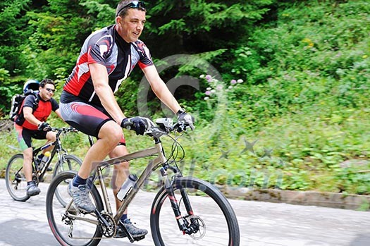 two friends have fun outdoor in nature and ride on muntain bike two friends have fun outdoor in nature and ride on muntain bike