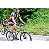 two friends have fun outdoor in nature and ride  on muntain bike
