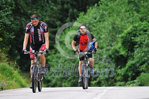 two friends have fun outdoor in nature and ride on muntain bike two friends have fun outdoor in nature and ride on muntain bike