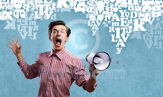 Young man in casual screaming in megaphone Young man in casual screaming in megaphone