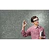 Young funny man in glasses against chalk blackboard