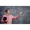 Young funny man in glasses against chalk blackboard