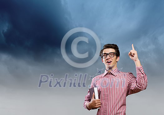 Young man in casual with book in hands Young man in casual with book in hands