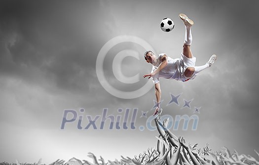 Football player in jump kicking the ball supported by fans Football player in jump kicking the ball supported by fans