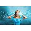 Young blond girl in blue dress listening music
