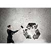 Young businesswoman in anger crashing stone recycle symbol