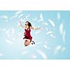 Young attractive woman in red dress jumping high