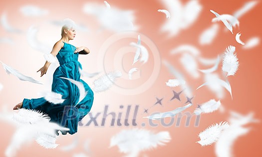 Young attractive woman in blue dress jumping high Young attractive woman in blue dress jumping high