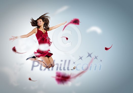 Young attractive woman in red dress jumping high Young attractive woman in red dress jumping high