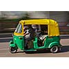 Indian auto (autorickshaw) taxi in the street. Motion blur. Delhi, India