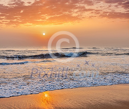 Sunrise on beach with dramatic sky. Marina beach, Chennai, India Sunrise on beach with dramatic sky. Marina beach, Chennai, India