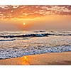 Sunrise on beach with dramatic sky. Marina beach, Chennai, India