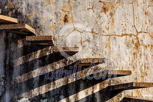 Abstract - stairs casting shadow on old weathered wall Abstract - stairs casting shadow on old weathered wall