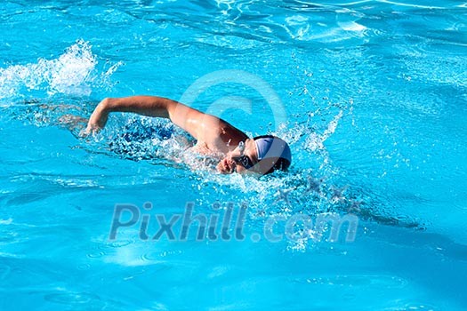 Athletic Man swimming in the pool Athletic Man swimming in the pool