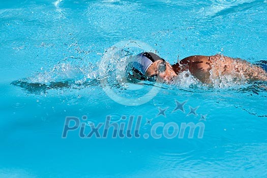 Athletic Man swimming in the pool Athletic Man swimming in the pool