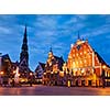 Riga Town Hall Square, House of the Blackheads, St. Roland Statue and St. Peter's Church illuminated in the evening, Riga, Latvia