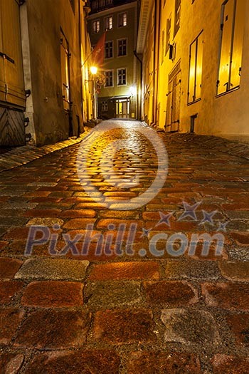 Tallinn Old Town street with cobblestones in night, Estonia