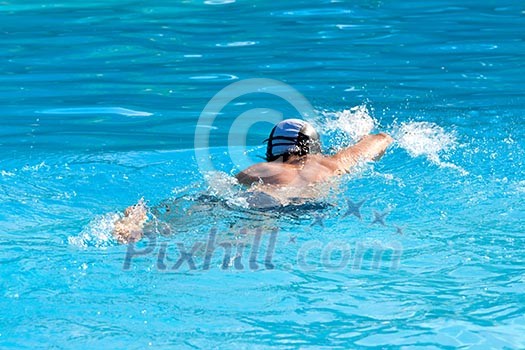 Athletic Man swimming in the pool