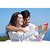 happy young couple taking selfie with cell phone