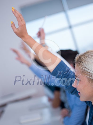 students group raise hands up in classroom students group raise hands up in classroom
