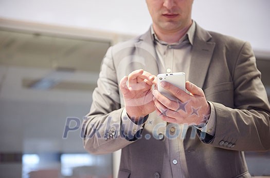 close up photo of business man work on phone at office close up photo of business man work on phone at office