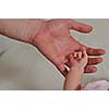 big man hand holding small baby hand