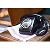 retro vintage black cable telephone on old wooden table