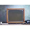Vintage retro look living room detail. Television, telephone and clock on wooden old table