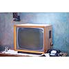 Vintage retro look living room detail. Television, telephone and clock on wooden old table