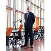 portrait of senior business man with grey beard and hair alone i modern office indoors