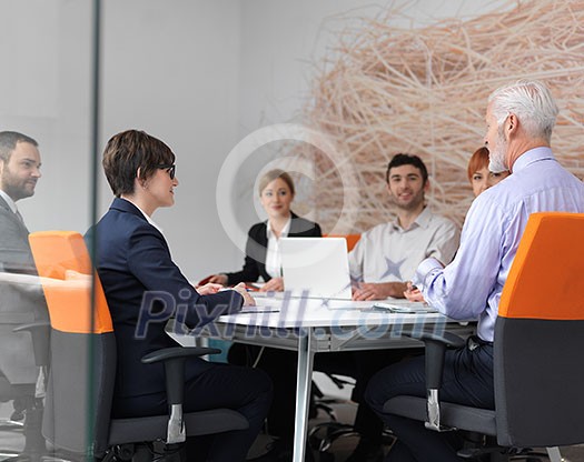 business people group on meeting at modern bright office indoors. Senior businessman as leader in discussion. business people group on meeting at modern bright office indoors. Senior businessman as leader in discussion.