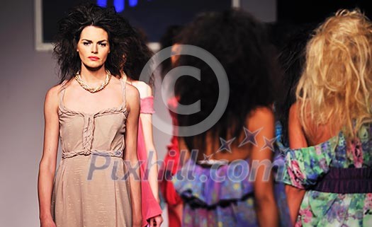 young beautiful model walking on fashion show piste young beautiful model walking on fashion show piste