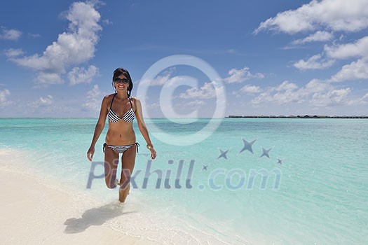 beautiful and happy young woman on beach have fun and relax on summer vacation over the crystal clear sea beautiful and happy young woman on beach have fun and relax on summer vacation over the crystal clear sea