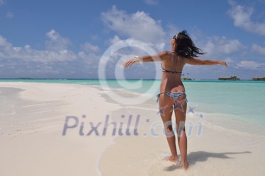 beautiful and happy young woman on beach have fun and relax on summer vacation over the crystal clear sea beautiful and happy young woman on beach have fun and relax on summer vacation over the crystal clear sea