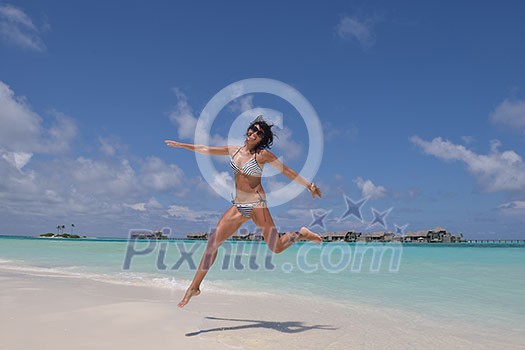 beautiful and happy young woman on beach have fun and relax on summer vacation over the crystal clear sea beautiful and happy young woman on beach have fun and relax on summer vacation over the crystal clear sea