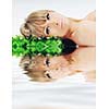 beautiful blonde woman face isolated on white with small green peace of grass
