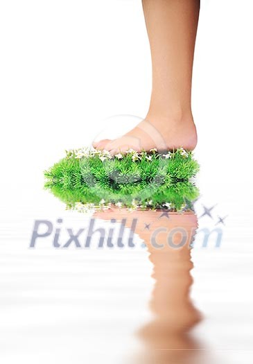 woman legs walking on small peace of green grass isolated on white representing last oasis concept woman legs walking on small peace of green grass isolated on white representing last oasis concept