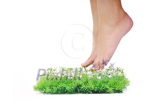 woman legs walking on small peace of green grass isolated on white representing last oasis concept woman legs walking on small peace of green grass isolated on white representing last oasis concept
