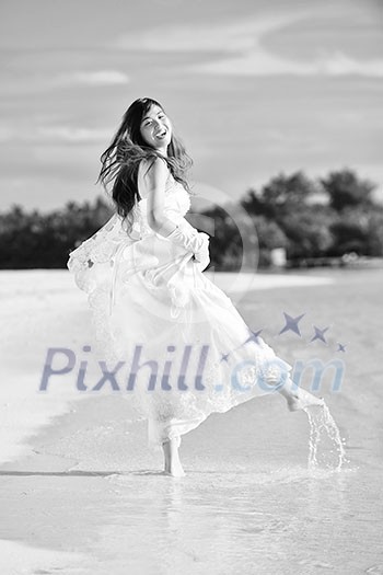 asian bride with a veil on the beach in the sky and blue sea. honeymoon on the fantastic island at summer asian bride with a veil on the beach in the sky and blue sea. honeymoon on the fantastic island at summer
