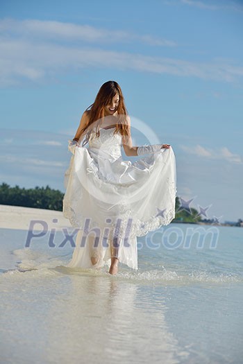 asian bride with a veil on the beach in the sky and blue sea. honeymoon on the fantastic island at summer asian bride with a veil on the beach in the sky and blue sea. honeymoon on the fantastic island at summer