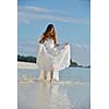 asian  bride with a veil on the beach in the sky and blue sea. honeymoon on the fantastic island at summer