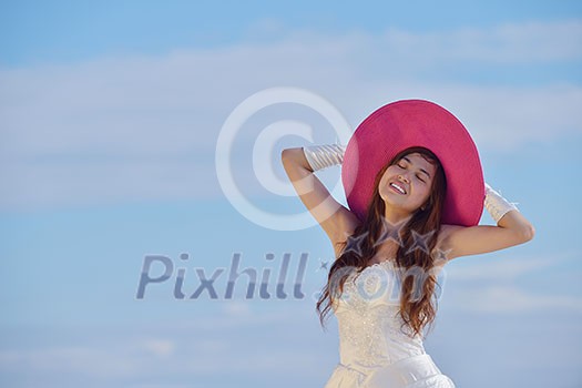 asian  bride with a veil on the beach in the sky and blue sea. honeymoon on the fantastic island at summer