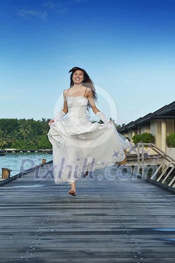 asian bride with a veil on the beach in the sky and blue sea. honeymoon on the fantastic island at summer asian bride with a veil on the beach in the sky and blue sea. honeymoon on the fantastic island at summer