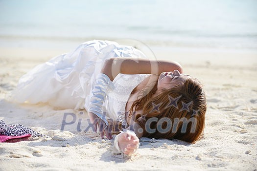 asian bride with a veil on the beach in the sky and blue sea. honeymoon on the fantastic island at summer asian bride with a veil on the beach in the sky and blue sea. honeymoon on the fantastic island at summer